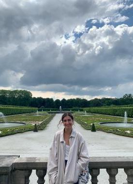 Spanish Language Resident standing in front of a garden